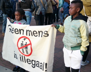 Vluchtelingenkinderen met een van onze spandoeken.